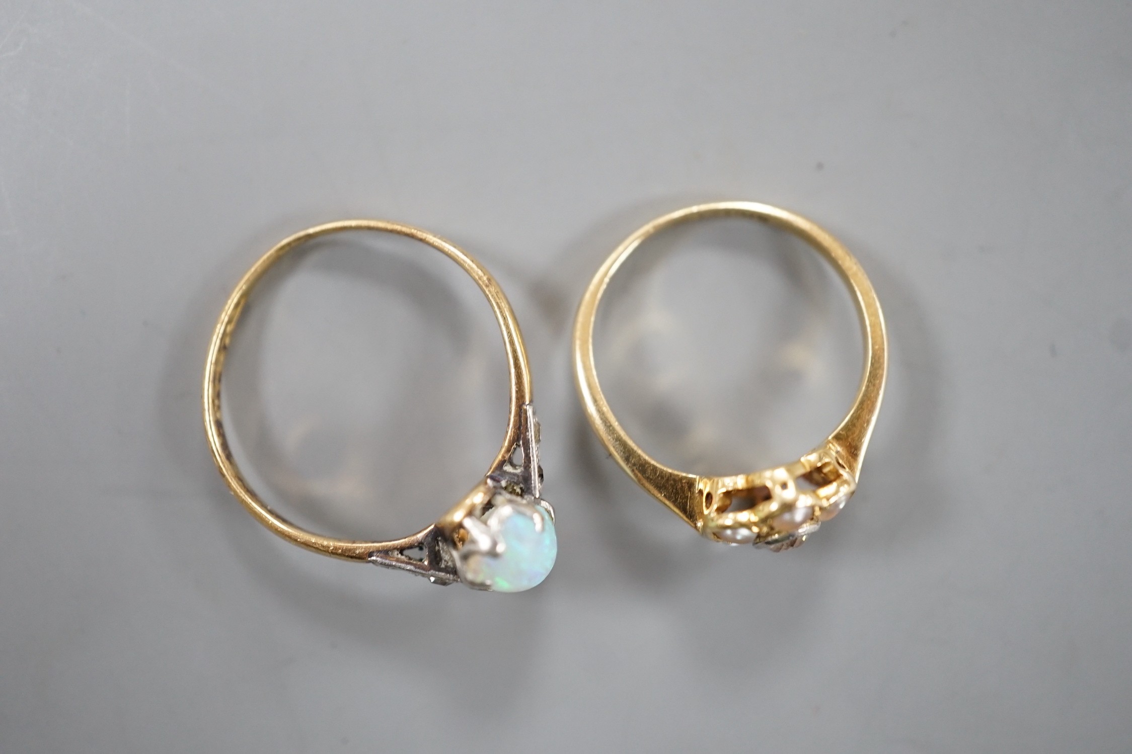 An 18ct and Plat, split pearl and diamond cluster set ring, size F/G and a similar white opal set ring with diamond set shoulders, size L, gross weight 4 grams.